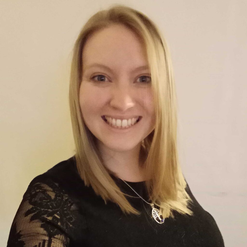 Head and shoulders photo of Kat McGregor smiling at the camera.