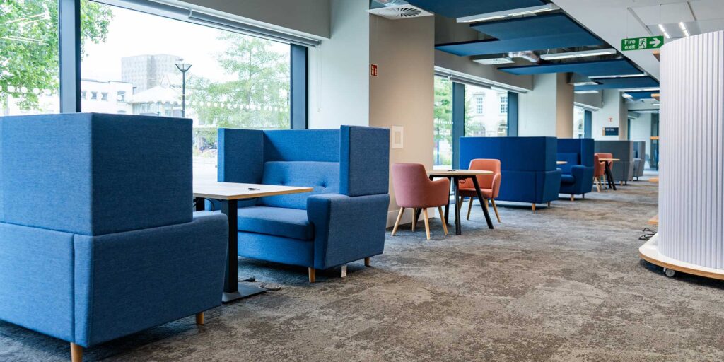 A study space within City Campus showing seating booths and work areas.